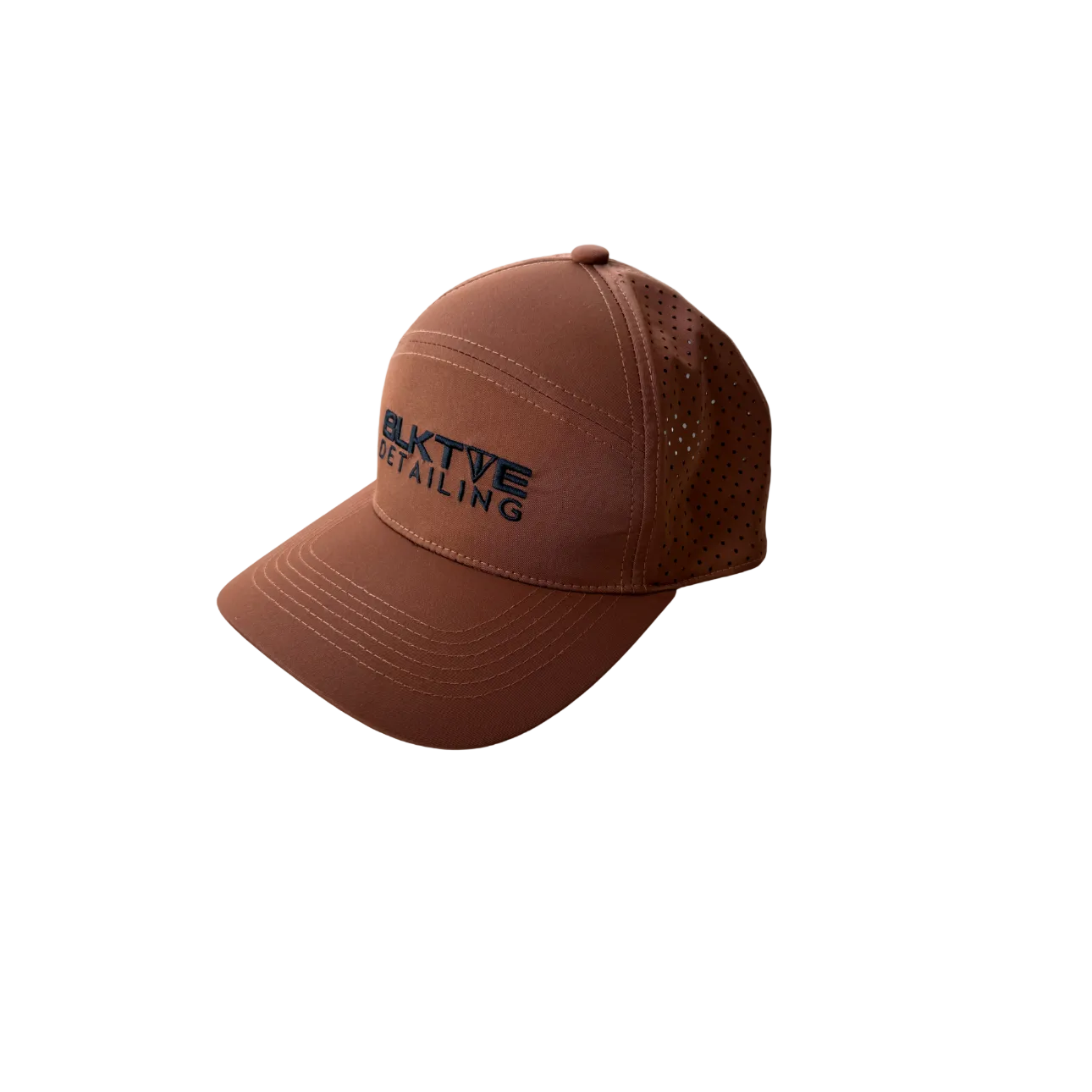 Brown cap with laser cut back and BLK TIE DETAILING branding on a white background